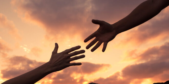 two hands reaching toward each other