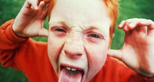 redhead boy sticking tongue out