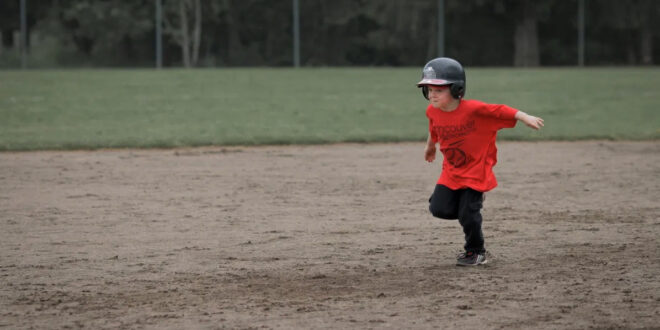 young boy running bases