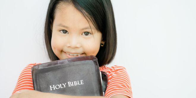 young girl holding a Bible
