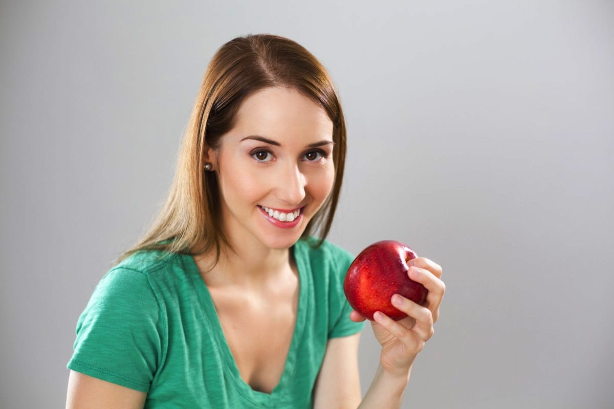 girl holding apple