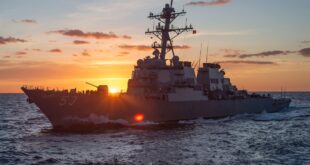 battleship at sunrise on the ocean