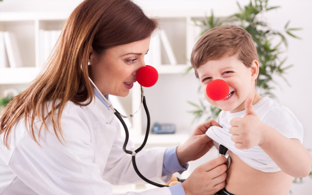 female doctor and child with red noses