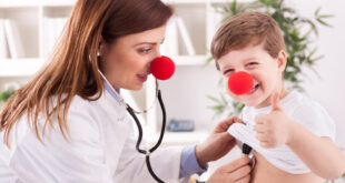 female doctor and child with red noses