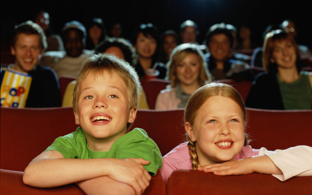 children enjoying movie in theater