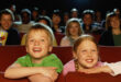 children enjoying movie in theater