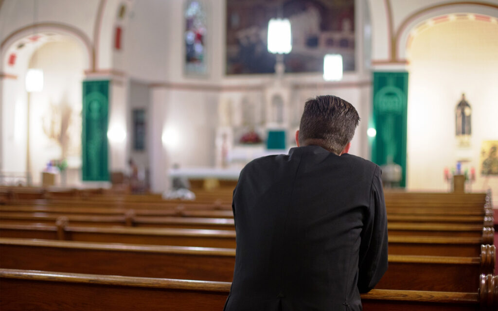 Man in church praying