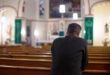 Man in church praying