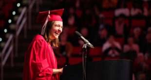 young woman laughs during graduation speech