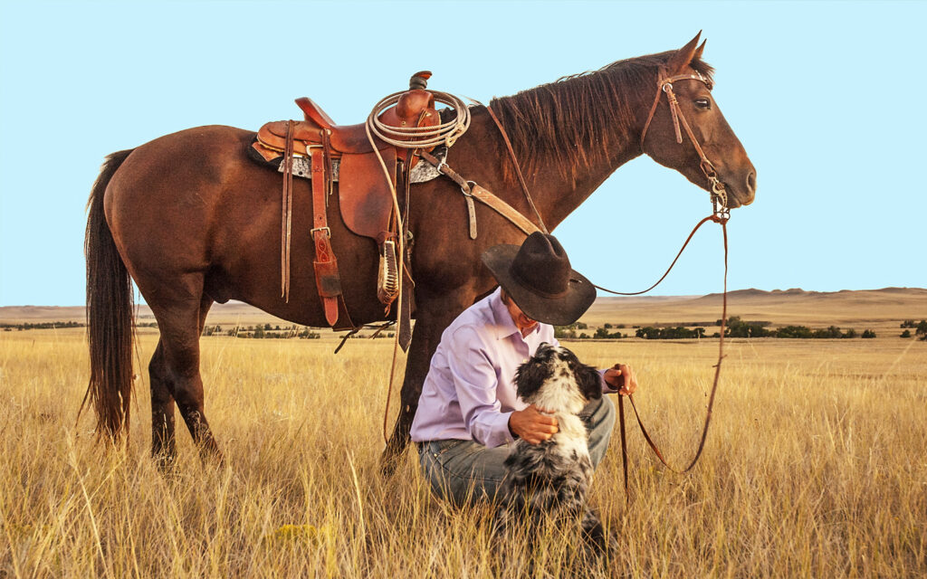 cowboy with his dog and horse