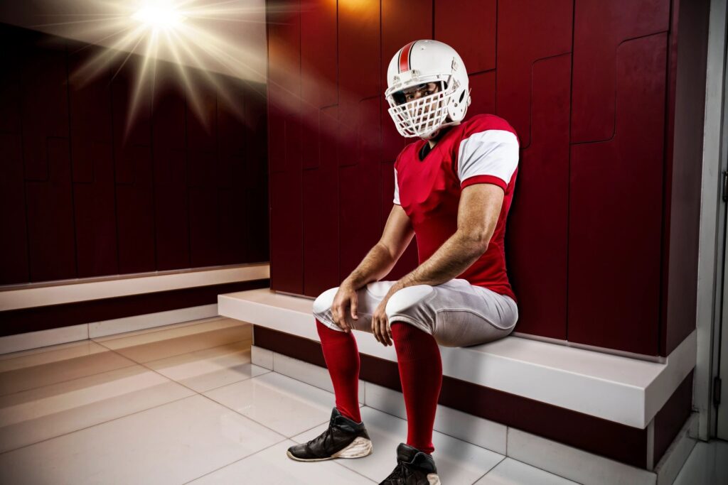 Football player sitting in locker room