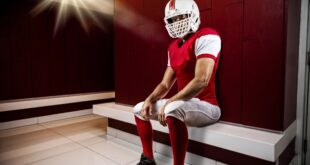 Football player sitting in locker room
