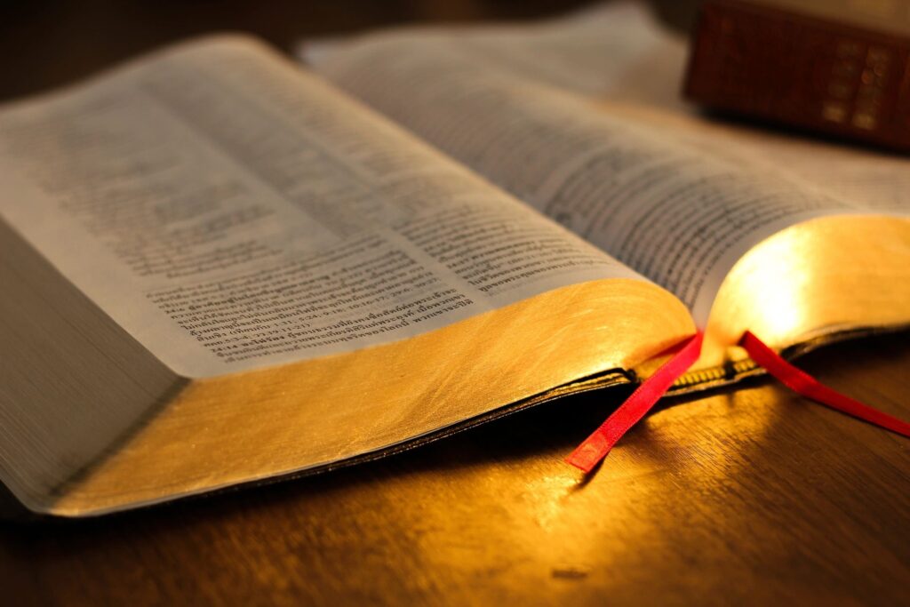 Open Bible with scripture on a table