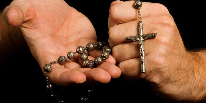 Hands holding a rosary
