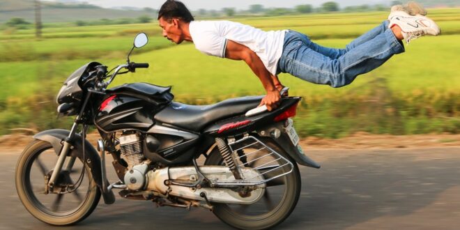 man flying behind motorcycle