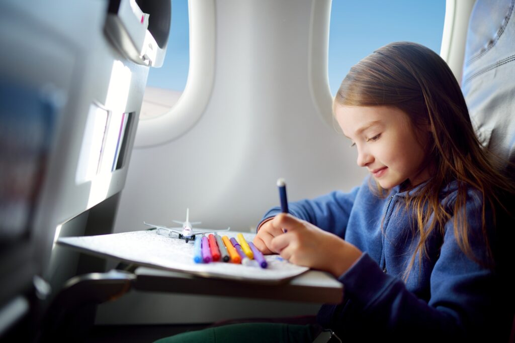 young girl sitting on plane