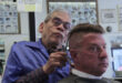barber cutting man's hair