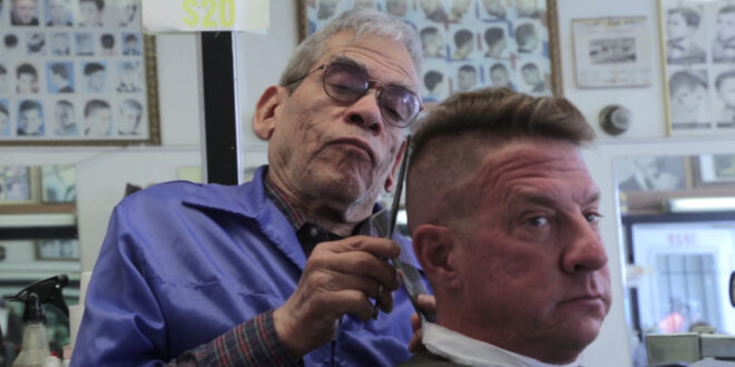 barber cutting man's hair
