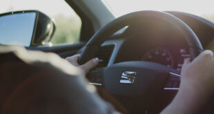 driver hands on steering wheel