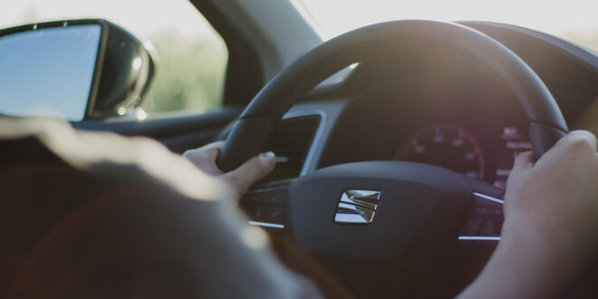 driver hands on steering wheel