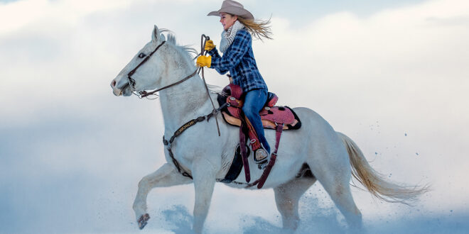 Blond Cowgirl riding horse