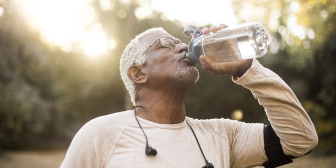 elderly man drinking water