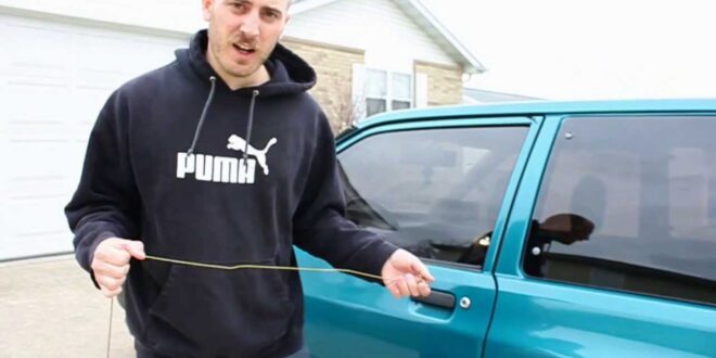 man uses coat hanger to open locked car